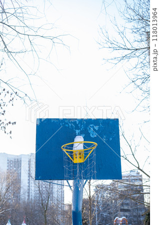 Snow-covered basketball hoop in park Snow-covered basketball hoop in park 118013964