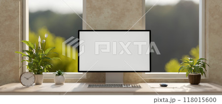 A modern loft office workspace features a computer with a white screen mockup on a table. A modern loft office workspace features a computer with a white screen mockup on a table. 118015600