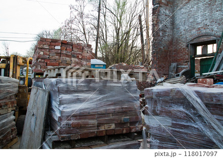 Construction Site Chaos with Bricks on Pallets and Forklift in Open Building Construction Site Chaos with Bricks on Pallets and Forklift in Open Building 118017097
