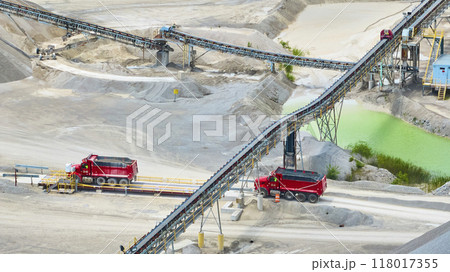 Aerial View of Quarry with Red Dump Trucks and Conveyor Belts Aerial View of Quarry with Red Dump Trucks and Conveyor Belts 118017355
