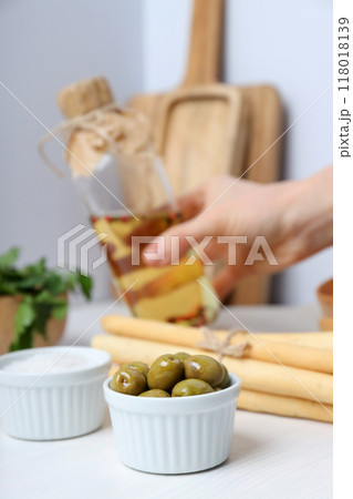The concept of Italian cuisine, green olives, on the table. 118018139