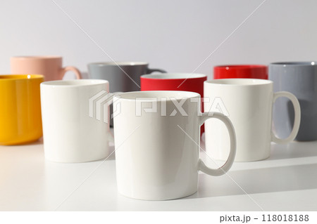 Multicolored beautiful cups on a light background Multicolored beautiful cups on a light background 118018188