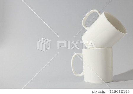 White glass cups on a light background White glass cups on a light background 118018195