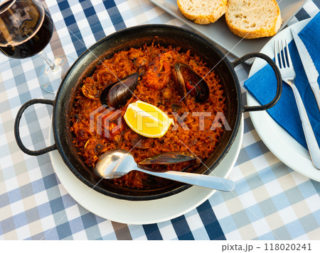 Popular dish of Spanish cuisine is paella with seafood Popular dish of Spanish cuisine is paella with seafood 118020241