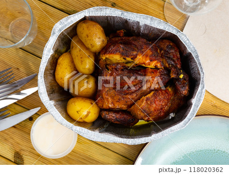 on table in baking dish is ready-to-eat fried chicken with potatoes in skin on table in baking dish is ready-to-eat fried chicken with potatoes in skin 118020362