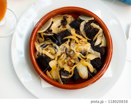 Morcilla con cebolla - fried blood sausage with onion on table Morcilla con cebolla - fried blood sausage with onion on table 118020838