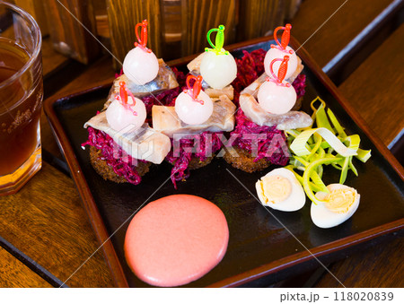 Canapes of pickled herring with beets 118020839