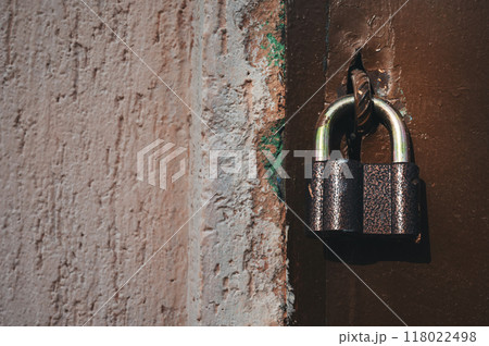 a lock hanging on an old door a lock hanging on an old door 118022498