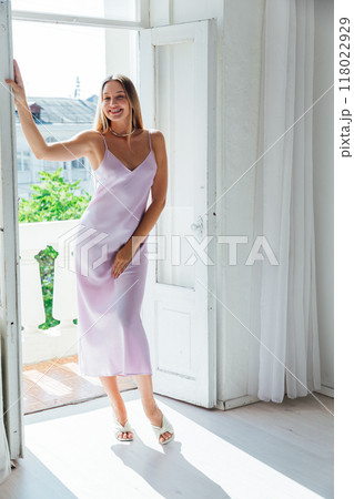 Beautiful fashion blonde woman in silk dress smiling Beautiful fashion blonde woman in silk dress smiling 118022929