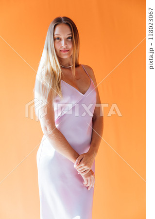 Beautiful fashion blonde woman in silk dress smiling Beautiful fashion blonde woman in silk dress smiling 118023067