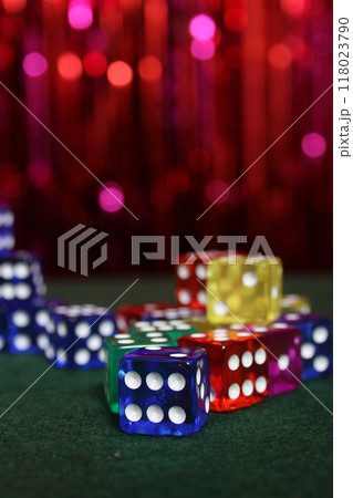 Stacks of Colorful Dice on Green Felt With Bokeh Background Stacks of Colorful Dice on Green Felt With Bokeh Background 118023790