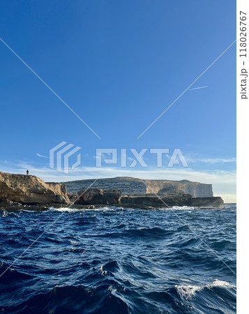 Beautiful view of the cliffs of the island of Gozo, Malta. Blue water of the Mediterranean Sea. Beautiful view of the cliffs of the island of Gozo, Malta. Blue water of the Mediterranean Sea. 118026767
