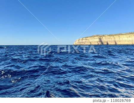 Beautiful view of the cliffs of the island of Gozo, Malta. Blue water of the Mediterranean Sea. Beautiful view of the cliffs of the island of Gozo, Malta. Blue water of the Mediterranean Sea. 118026769