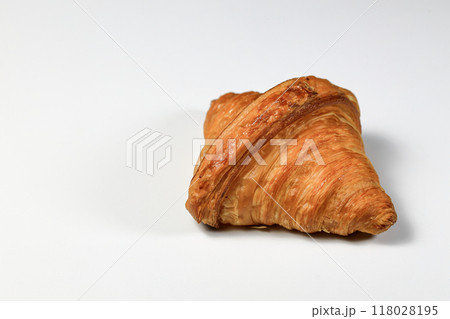 Freshly baked croissant,  Brown crispy croissants isolated on white background. French pastry closeup photo. Buttered bread croissant. 118028195