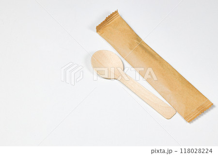 Wooden spoon, disposable tableware, Eco-friendly materials spoon with paper package isolated on white background. Wooden spoon, disposable tableware, Eco-friendly materials spoon with paper package isolated on white background. 118028224