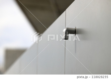 Roof PVC drain pipe or gutter, Rainwater downpipe. House drainage system on modern building. 118028235