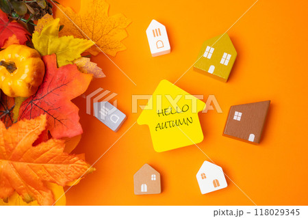 Miniature houses with the inscription hello autumn and fall leaves. Concept of beginning of new autumn season. Real estate and housing. Flat lay 118029345