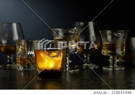 Glass of whiskey on a black table. Glass of whiskey on a black table. 118031496
