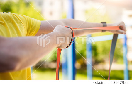 Man exercising with resistance rubber band 118032933
