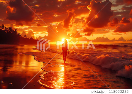 A woman walking on the beach at sunset 118033283