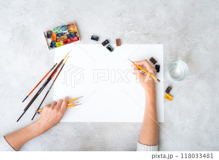 Top view of girl's hands drawing 118033481