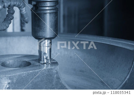 The CNC milling machine rough cutting the cast iron mold parts by indexable tools in the light blue scene. 118035341