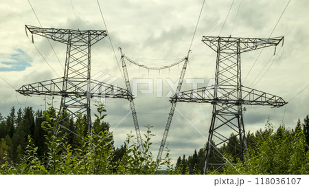 high voltage power lines against a gloomy sky 118036107