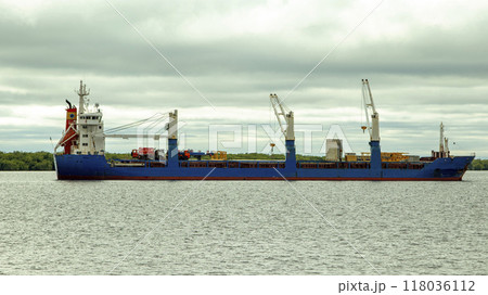 A large cargo sea vessel is at anchor, a dry cargo ship is at anchor A large cargo sea vessel is at anchor, a dry cargo ship is at anchor 118036112