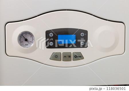 Close-up of a digital control panel on a modern boiler showing pressure and settings. 118036501