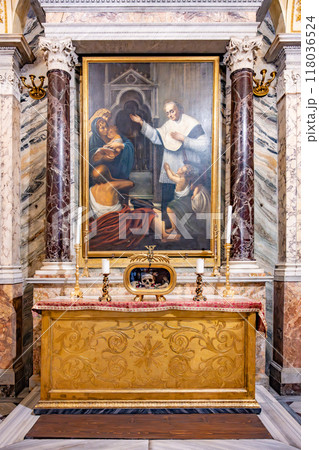 Visitors admire the ornate altar and painting honoring Saint Valentine at Basilica of Santa Maria in Cosmedin, a historic site in Rome, Italy, known for its rich religious significance and heritage. 118036524