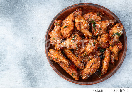 Caramelized in sause chicken wings  . Bar-b-q food background photo 118036760