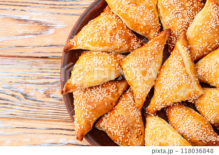 Homemade triangle puff pastry with meat on rustic background . Samosa Homemade triangle puff pastry with meat on rustic background . Samosa 118036848