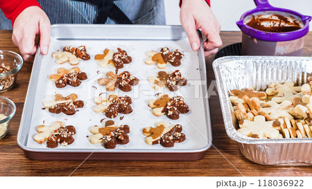 Crafting star-shaped holiday cookies dipped in chocolate and sprinkled with variety of toppings. 118036922