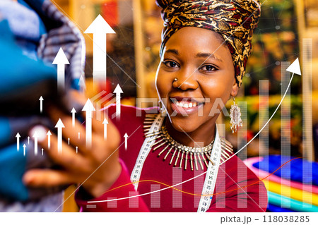 A woman is holding a piece of clothing and smiling 118038285