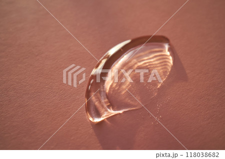 Beautiful volumetric drop of cosmetic product on a pink background. 118038682