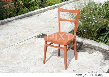 A freshly painted chair in the garden. A freshly painted chair in the garden. 118038809
