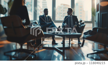 Blurred image of business professionals in suits having a meeting in a modern office lounge with large windows and cityscape view. 118040215