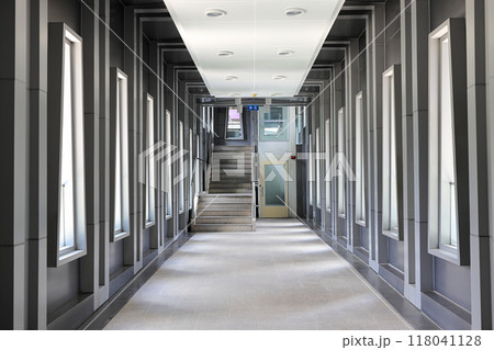 Pedestrian pathway or corridor or hallway between train station and other building. 118041128