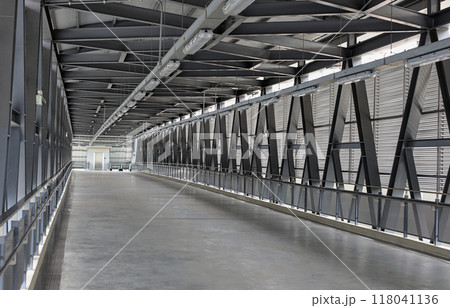 Pedestrian pathway or corridor or hallway between train station and other building. Pedestrian pathway or corridor or hallway between train station and other building. 118041136