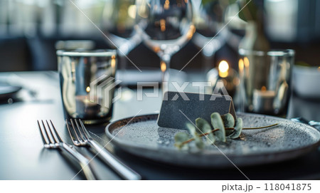 A beautifully arranged dining table awaits guests, showcasing a stylish plate A beautifully arranged dining table awaits guests, showcasing a stylish plate 118041875
