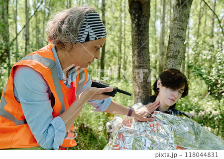 Checking pulse of unconscious camper Checking pulse of unconscious camper 118044831