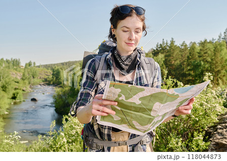 Looking at folded paper map of locality Looking at folded paper map of locality 118044873
