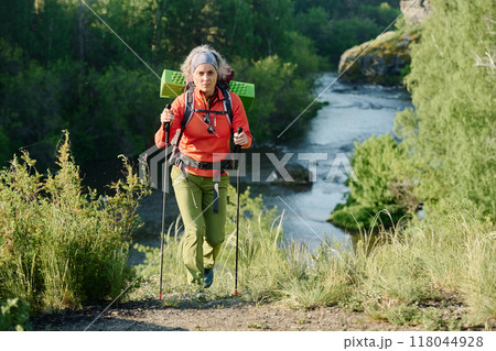 Active mature woman with trekking sticks 118044928