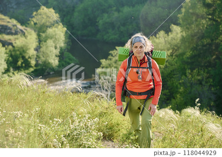Female hiker walking down forest path 118044929