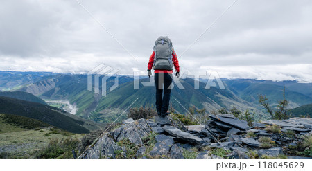Hiking woman on high altitude mountain top 118045629