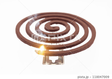 A mosquito coil with smoke coming out of it A mosquito coil with smoke coming out of it 118047009
