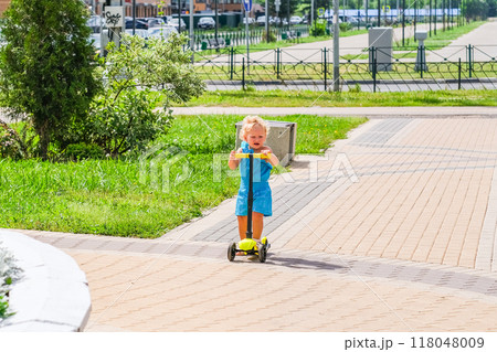 blonde curly girl at a city park 118048009