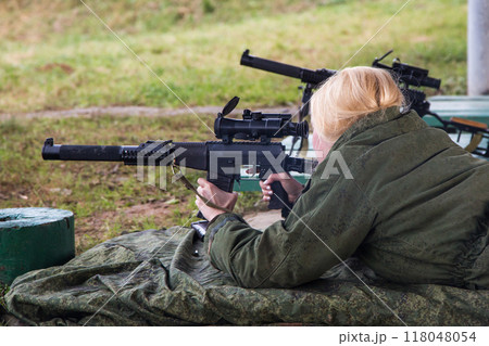 Man shooting at a target. Unformal shooting range Man shooting at a target. Unformal shooting range 118048054