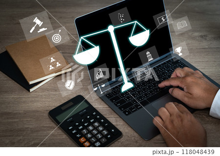 laptop computer with legal law scale Male judge working on laptop computer laptop computer with legal law scale Male judge working on laptop computer 118048439