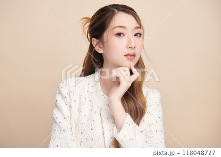 Beautiful young asian woman with clean fresh skin on beige background, Face care, Facial treatment, Cosmetology, beauty and spa, Asian women portrait. 118048727